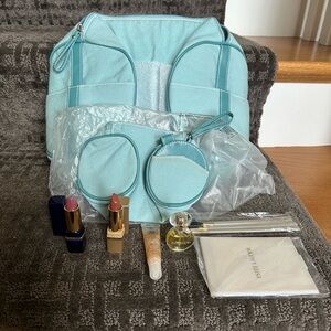 Estée Lauder small duffel cosmetic bag with cosmetics
